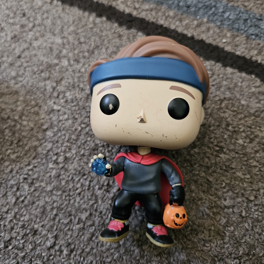 Funko Pop Figure with Blue Headband and Red Cape